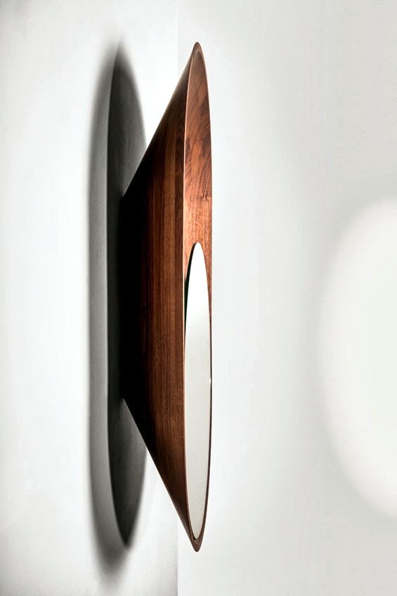A mirror wall design in polished brass and black walnut