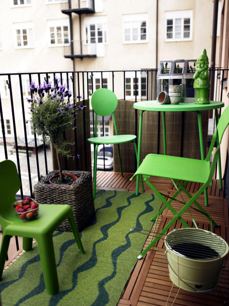 Garden furniture and green patterned runner on the balcony of the ...