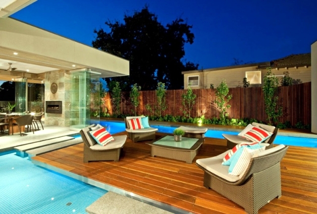 Modern House in Canterbury - A wooden deck by the pool