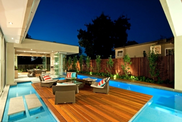 Modern House in Canterbury - A wooden deck by the pool