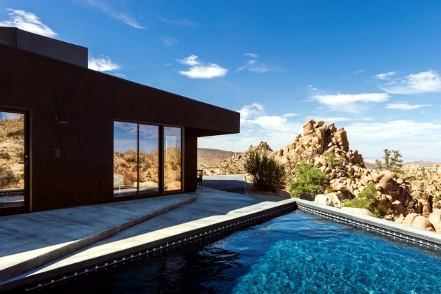 A black modern home in the California desert