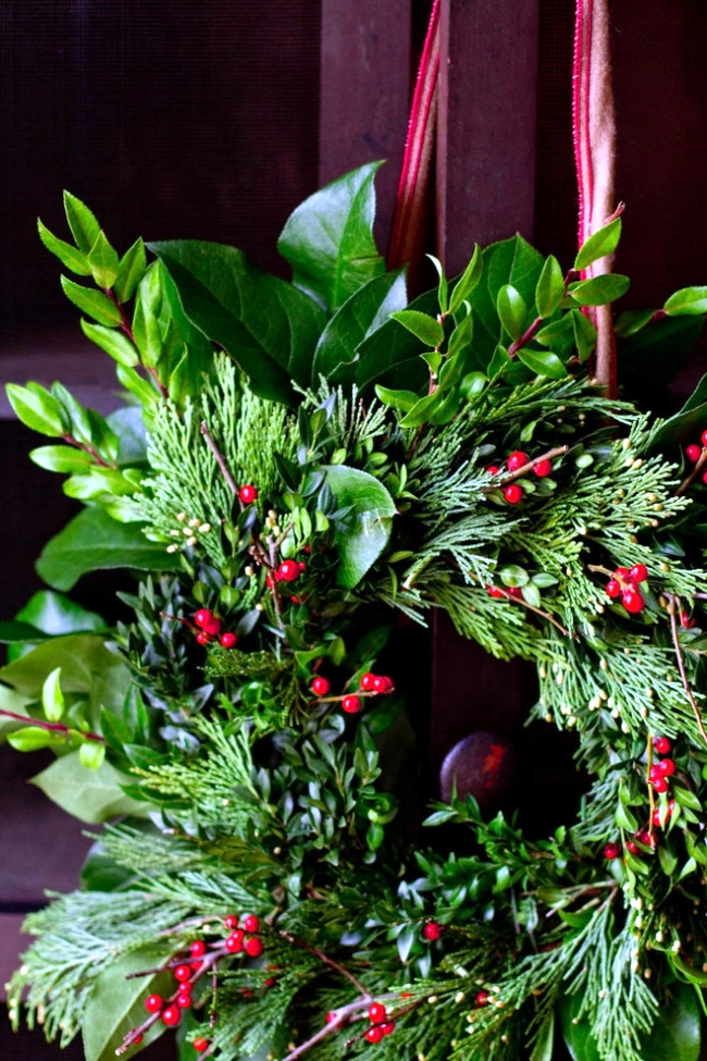 Playing with a beautiful door wreath evergreen Advent