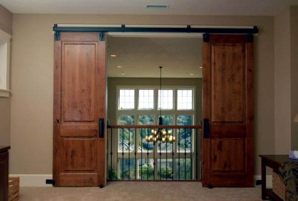 Wooden sliding door give the interior a rustic touch