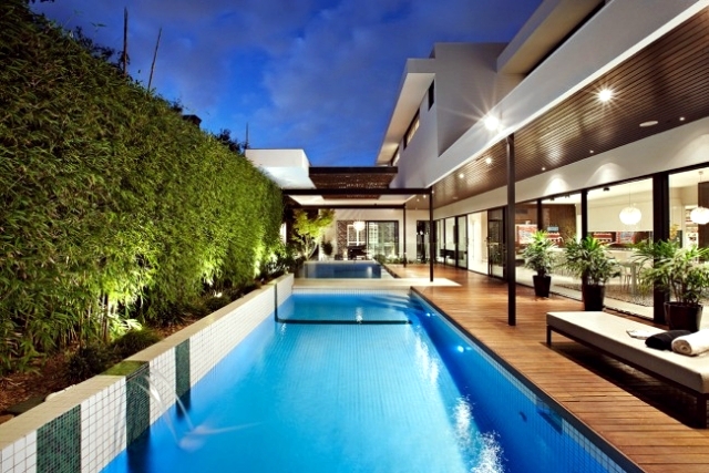 Modern house with pool surrounded by a spacious deck wood