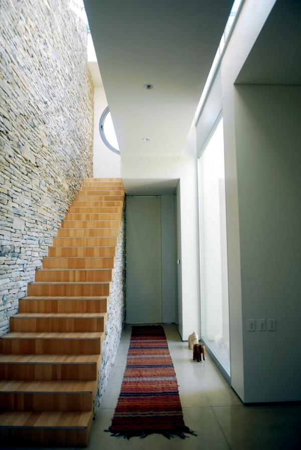 Architectural character home surrounded by loft, surrounded by greenery and water