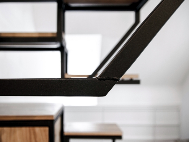 A suspended staircase design workspace and provides plenty of storage
