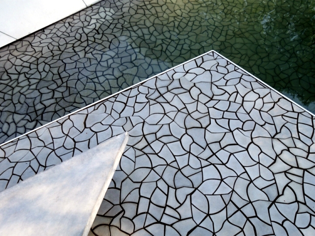 Concrete sidewalk slab KAZA looks cracked earth