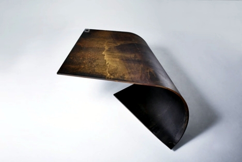 Bowed designer steel table amazed with perfect balance