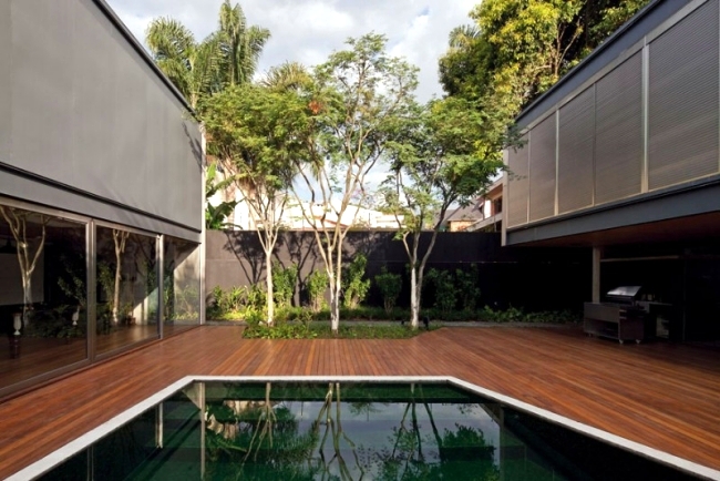 Concrete building with glass facade of Una Arquitetos offers living close to nature