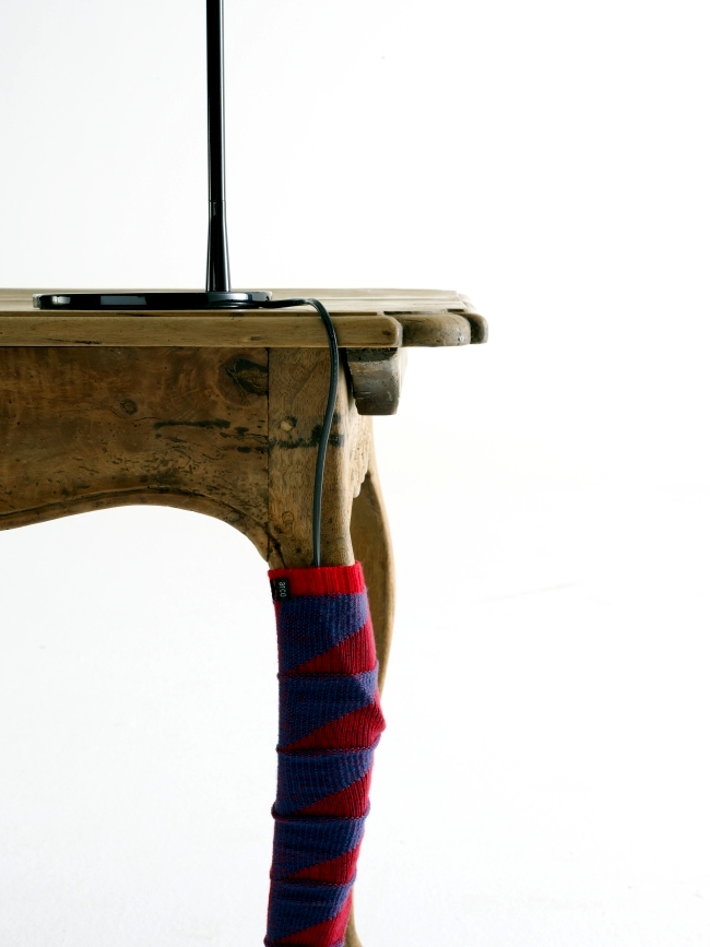 Knitted sock serves as a cable concealment for desktop design