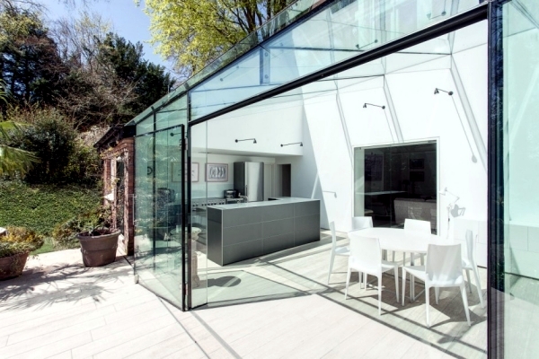 Modern house of glass serves as an attachment from the old house in England