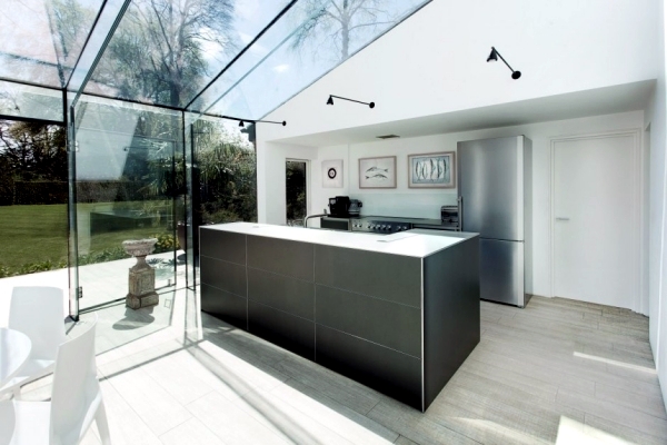Modern house of glass serves as an attachment from the old house in England