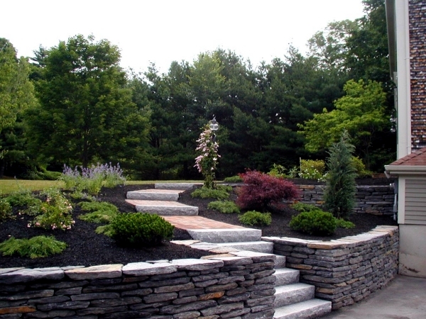 Stone wall in the garden slope stabilization, which provides visual and noise