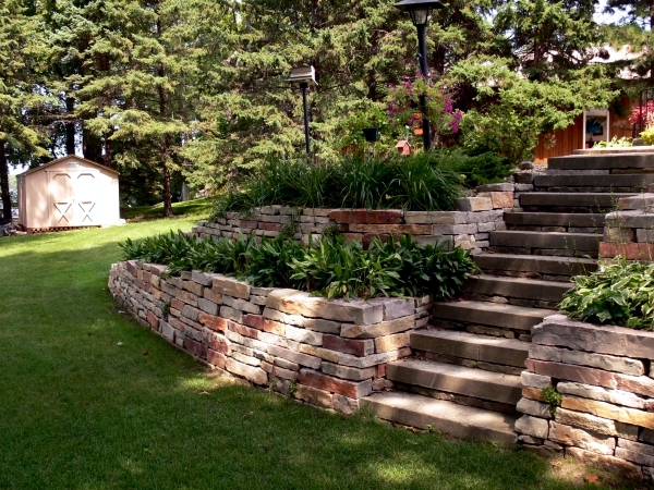 Stone wall in the garden slope stabilization, which provides visual and noise