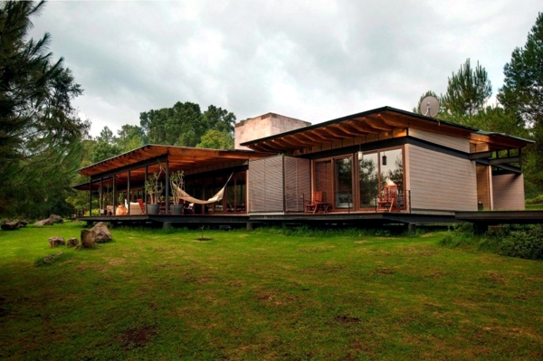 Wooden house with glass facade thrilled with scenic views of the forest